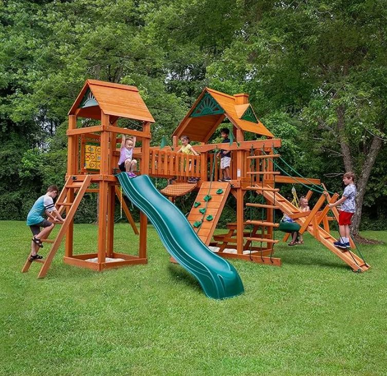 Gorilla Playsets Pioneer Peak Treehouse Wooden Swing Set with Tire Swing and Clatter Bridge and Tower